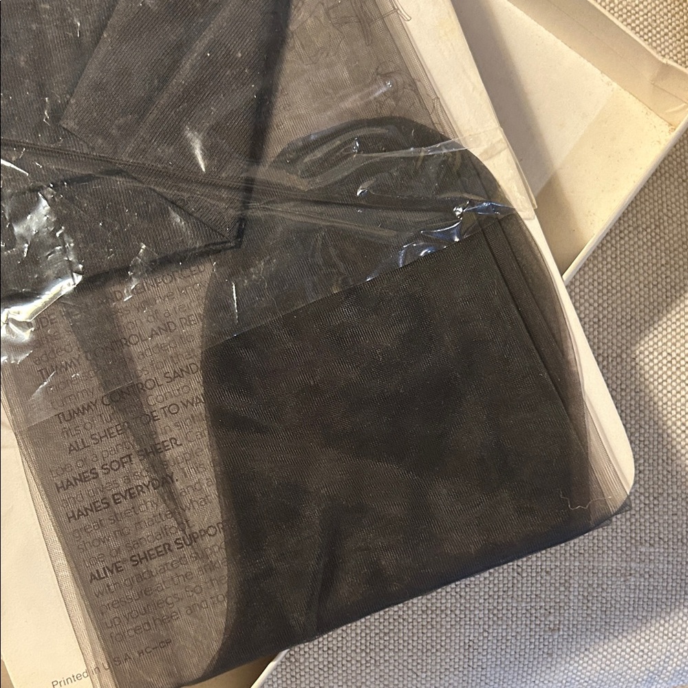 Oleg Cassini Gold Embossed Packaging with black sheer stockings